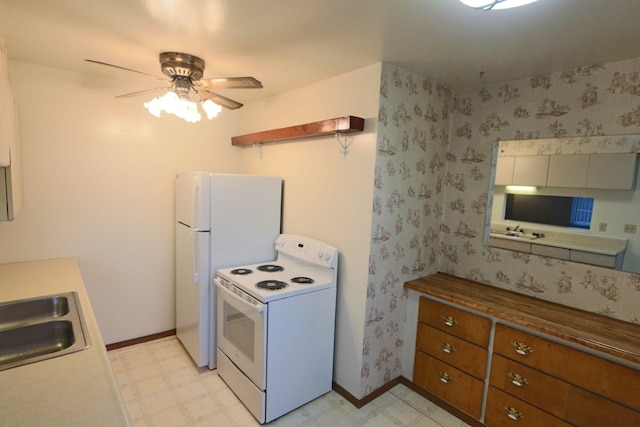 kitchen featuring butcher block counters, sink, white appliances, and ceiling fan