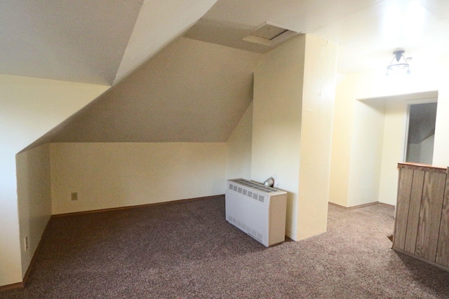 bonus room featuring vaulted ceiling, carpet flooring, and radiator heating unit