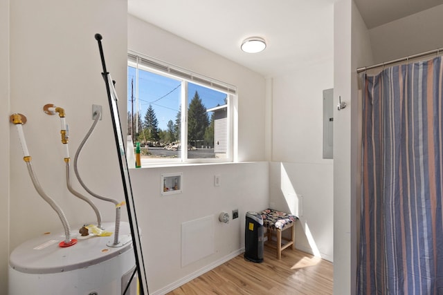 bathroom featuring hardwood / wood-style flooring, electric panel, a shower with shower curtain, and water heater