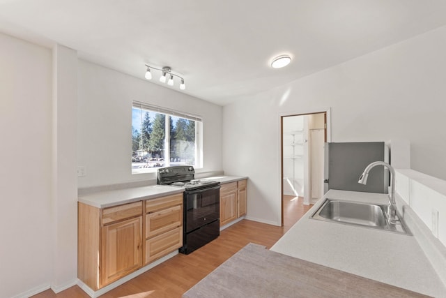 kitchen with light hardwood / wood-style floors, black range with electric stovetop, light brown cabinetry, and sink