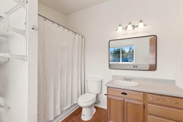 bathroom with vanity, curtained shower, wood-type flooring, and toilet