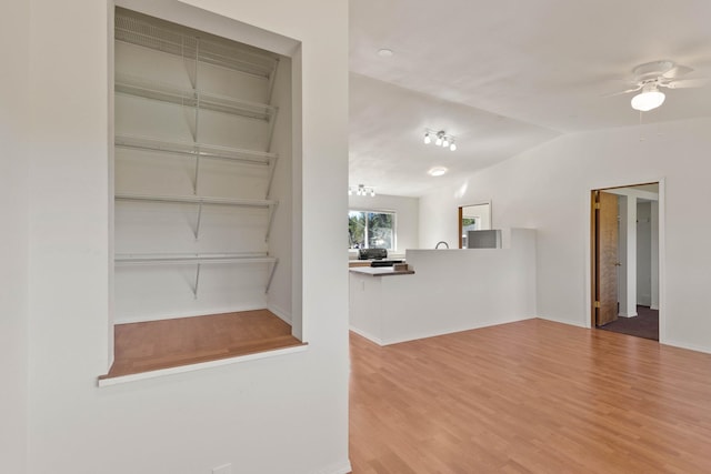 interior space featuring lofted ceiling, hardwood / wood-style floors, and ceiling fan