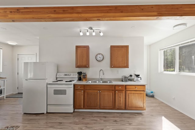 kitchen featuring sink, white appliances, and light hardwood / wood-style floors