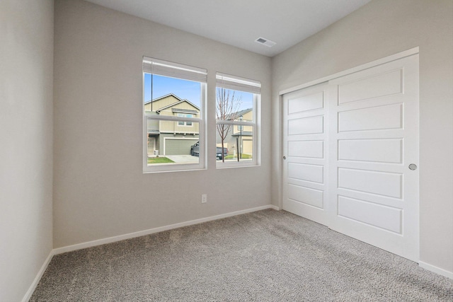 unfurnished bedroom with a closet and carpet flooring