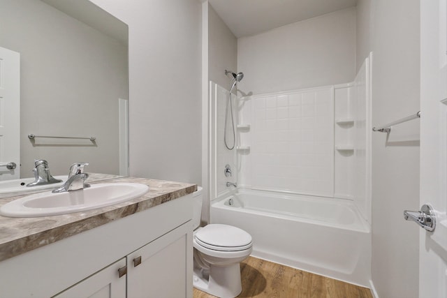 full bathroom featuring toilet, shower / bathing tub combination, wood-type flooring, and vanity