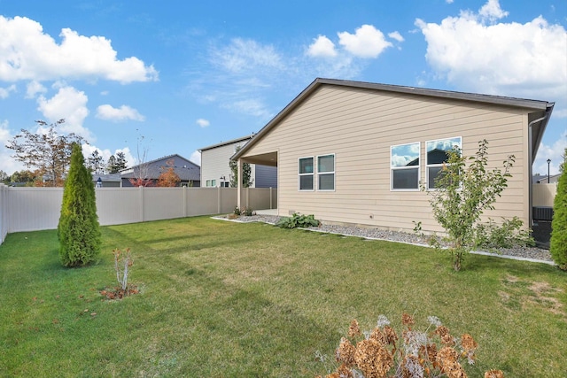 rear view of property featuring a lawn