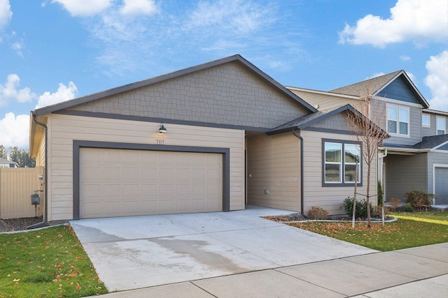 view of front of property featuring a garage and a front lawn