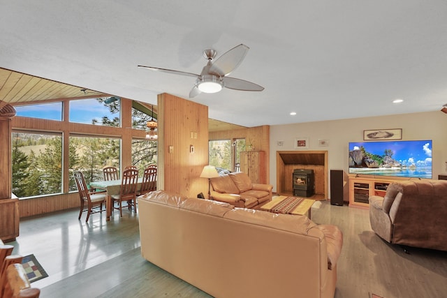 living room featuring lofted ceiling, a wealth of natural light, and light hardwood / wood-style floors