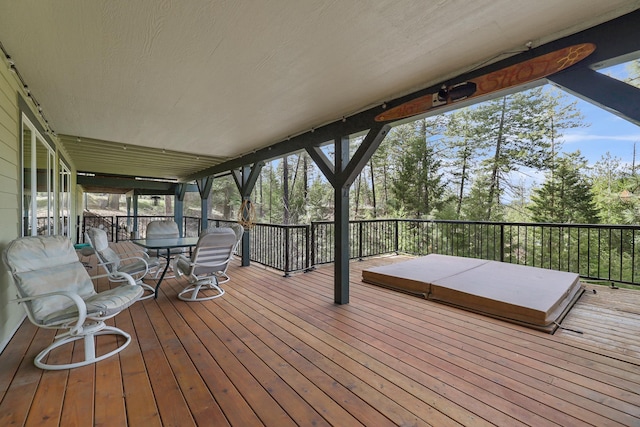 wooden deck featuring a covered hot tub