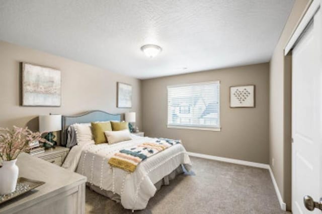 carpeted bedroom featuring a textured ceiling