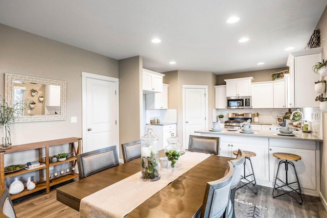 dining space with dark hardwood / wood-style flooring