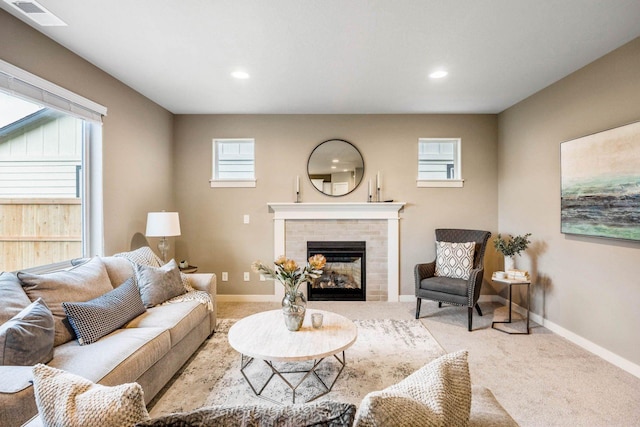 living room featuring a brick fireplace and light colored carpet