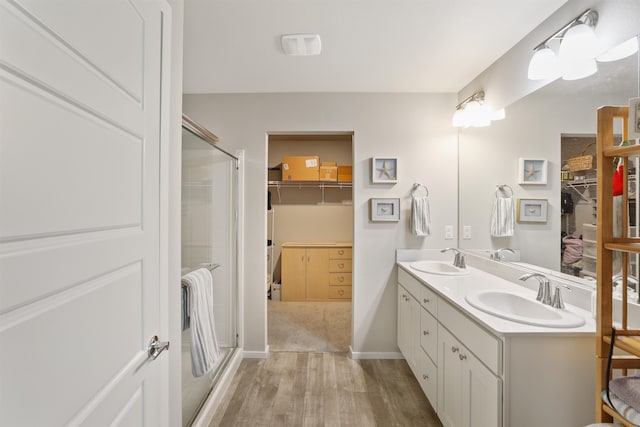 bathroom with vanity, wood-type flooring, and a shower with shower door