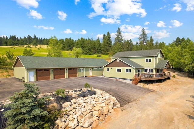 view of front of house with a wooden deck and a garage