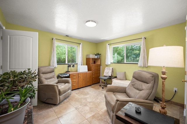 living room featuring light tile patterned flooring and a healthy amount of sunlight