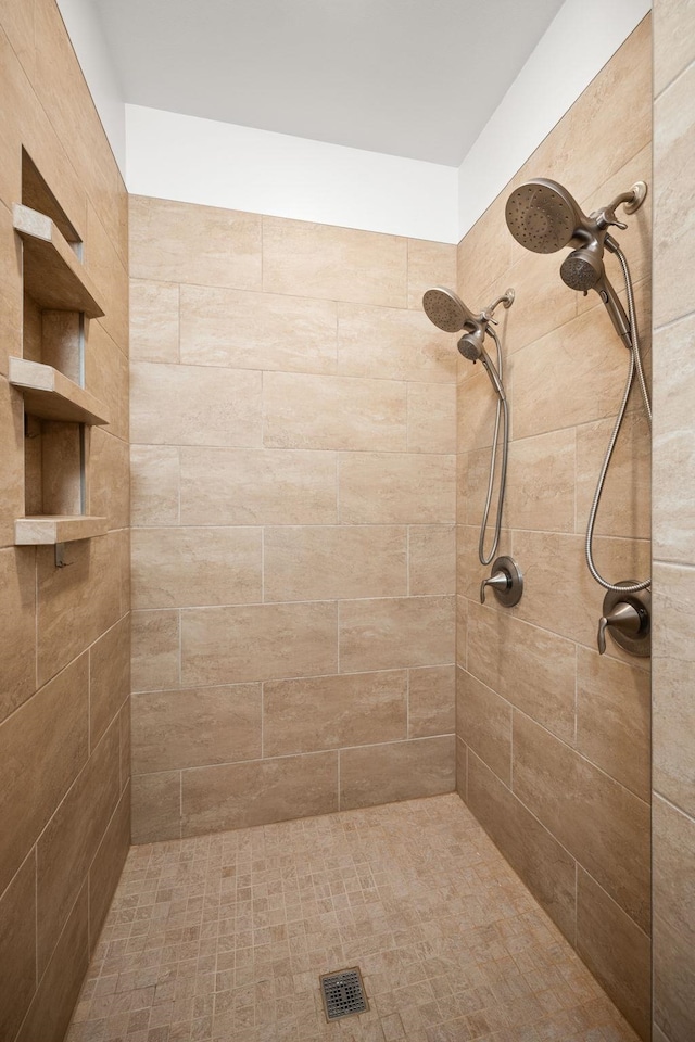 bathroom with tiled shower