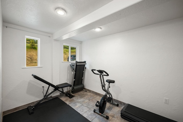 exercise room with a textured ceiling