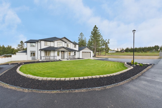 view of front of property with a garage and a front yard