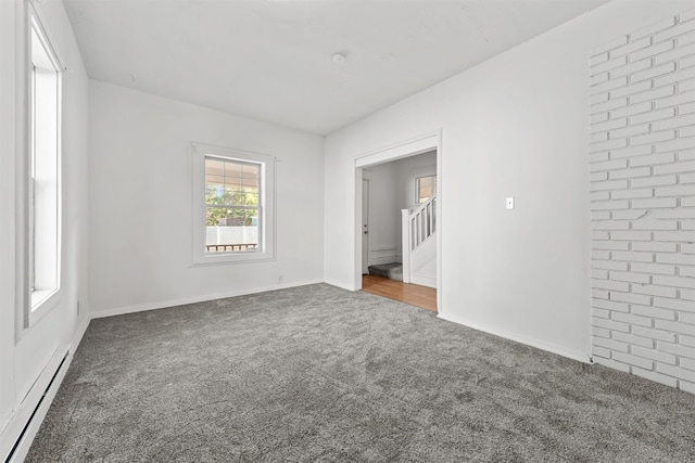 spare room with a baseboard radiator and carpet floors