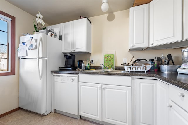 kitchen with sink, light tile patterned floors, white cabinets, and white appliances