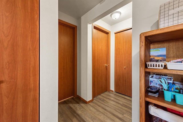 corridor featuring dark hardwood / wood-style flooring