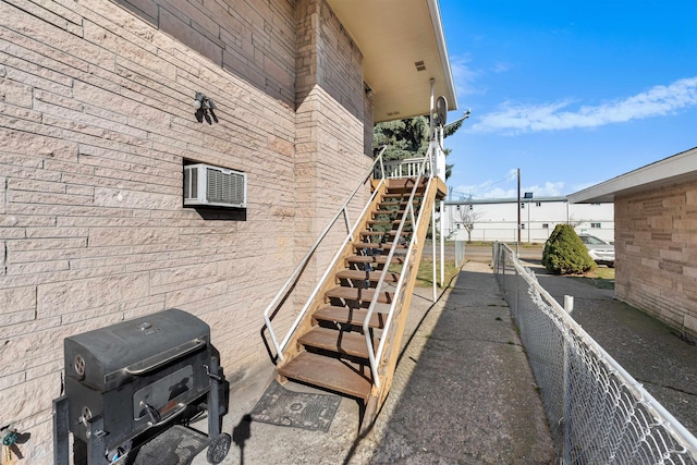 view of home's exterior with an AC wall unit