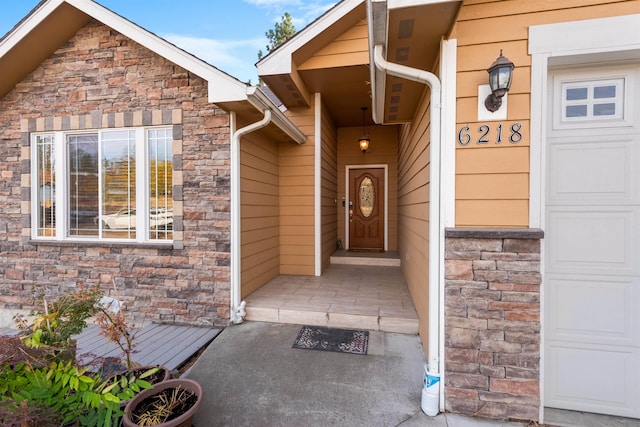 doorway to property with a garage