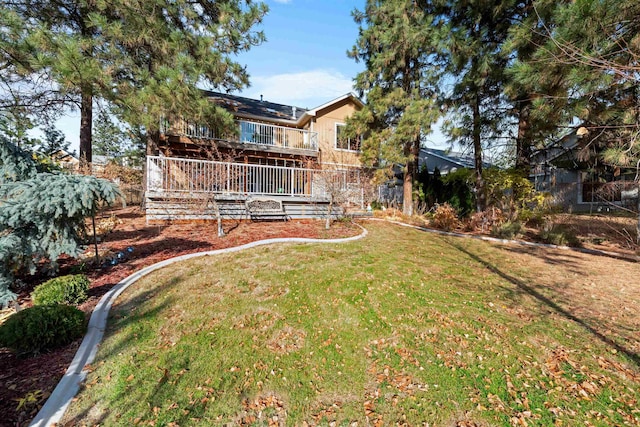 view of yard with a balcony