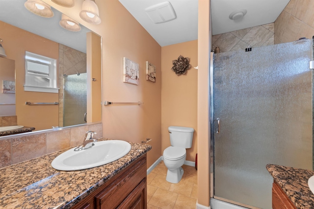 bathroom featuring vanity, toilet, a shower with shower door, and tile patterned flooring