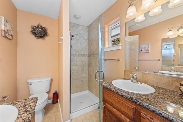 bathroom featuring an enclosed shower, vanity, tile patterned flooring, and toilet