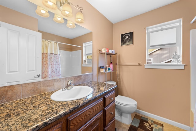 bathroom featuring a chandelier, decorative backsplash, vanity, walk in shower, and toilet