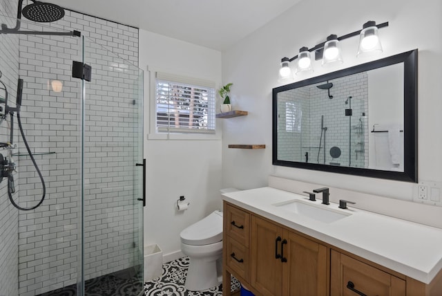 bathroom featuring a shower with door, vanity, tile patterned floors, and toilet