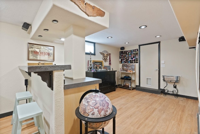 bar featuring light hardwood / wood-style flooring