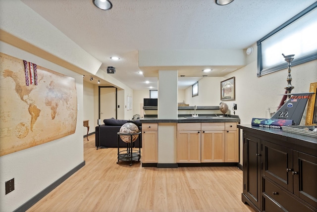 kitchen with a wealth of natural light, sink, light brown cabinets, and light hardwood / wood-style floors