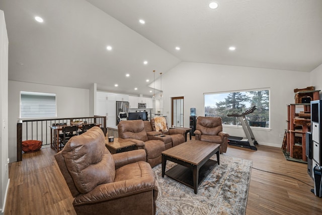 living room featuring light hardwood / wood-style flooring and high vaulted ceiling