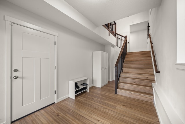 stairs featuring hardwood / wood-style flooring