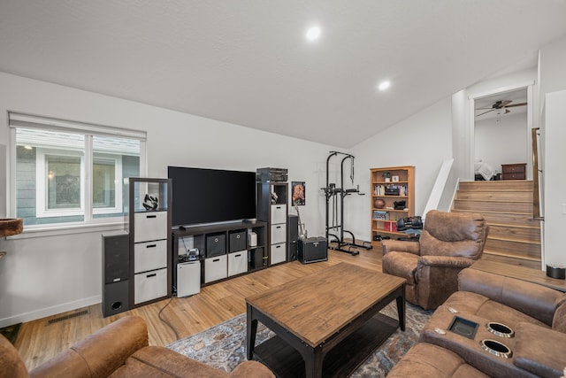 living room featuring hardwood / wood-style flooring and lofted ceiling