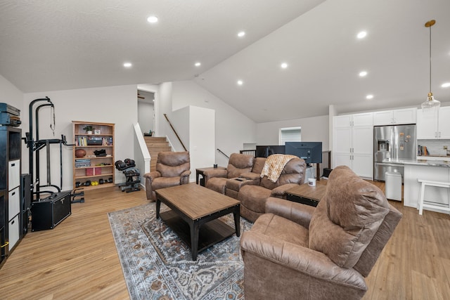 living room featuring vaulted ceiling and light wood-type flooring