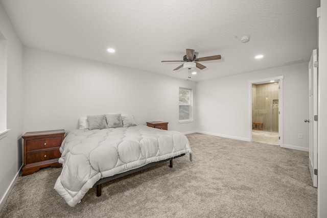 carpeted bedroom with ceiling fan, ensuite bathroom, and a textured ceiling