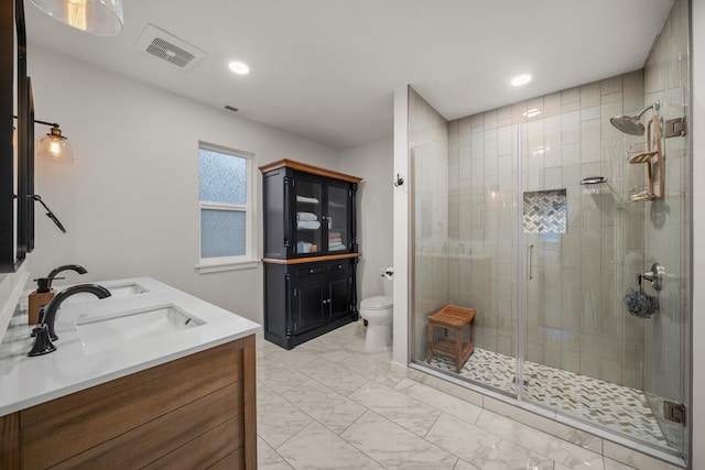 bathroom featuring vanity, an enclosed shower, and toilet