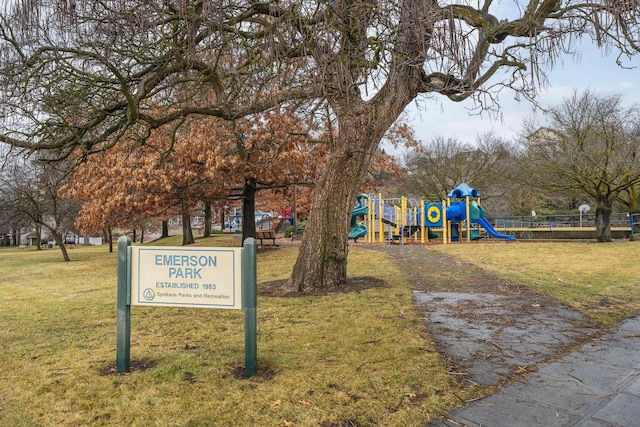 exterior space with a playground and a lawn