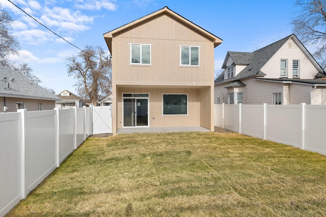 rear view of house with a yard and a patio