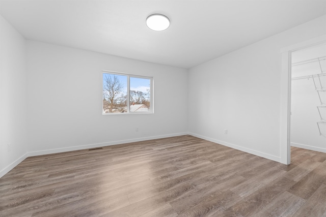 spare room with light hardwood / wood-style flooring