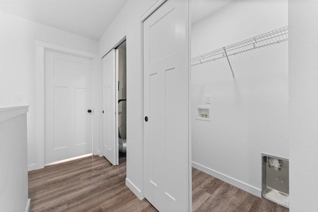 clothes washing area featuring washer hookup and dark hardwood / wood-style flooring