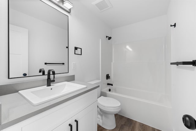 full bathroom with shower / bath combination, vanity, hardwood / wood-style flooring, and toilet