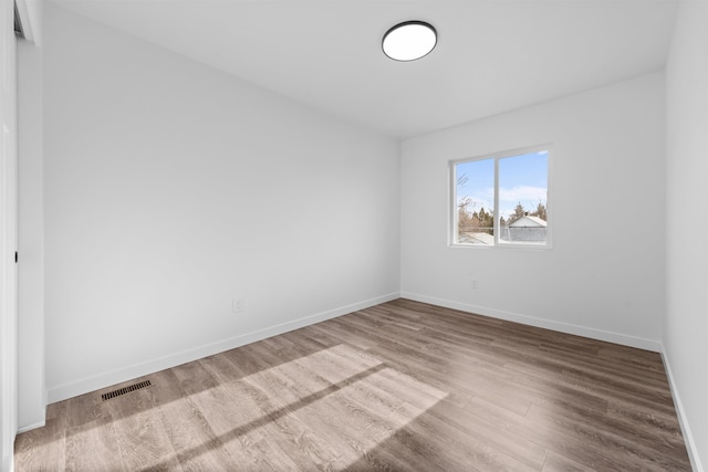 spare room featuring wood-type flooring