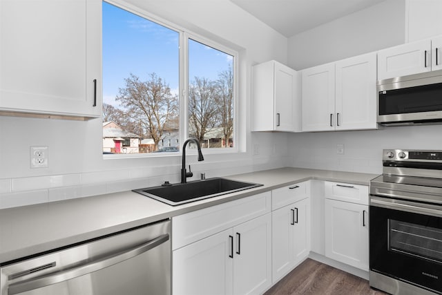 kitchen featuring white cabinetry, sink, dark hardwood / wood-style flooring, and stainless steel appliances