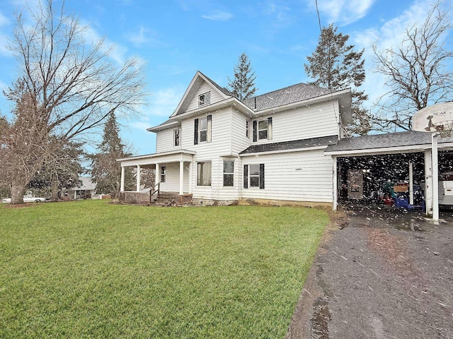 view of front facade featuring a garage, a front lawn, a carport, and a porch