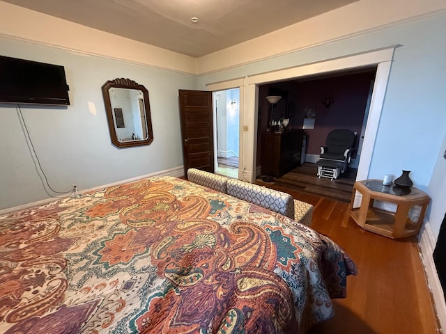 bedroom with dark hardwood / wood-style flooring