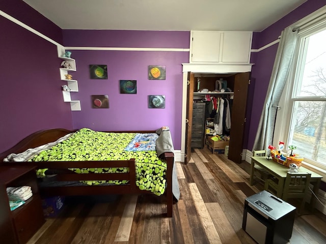 bedroom featuring a closet and dark hardwood / wood-style floors